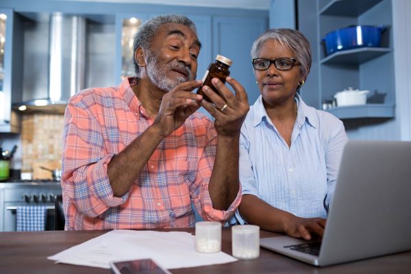 couple looks at medication bottle 