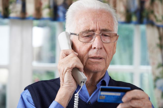 Seniors looking at a credit card
