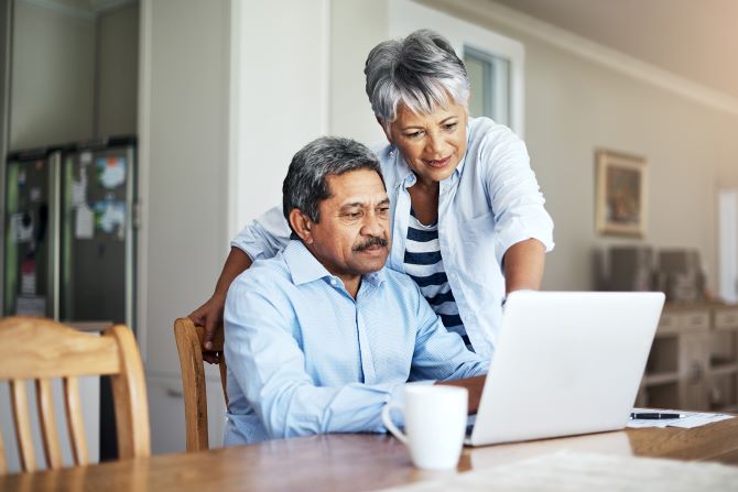 Seniors looking at a laptop