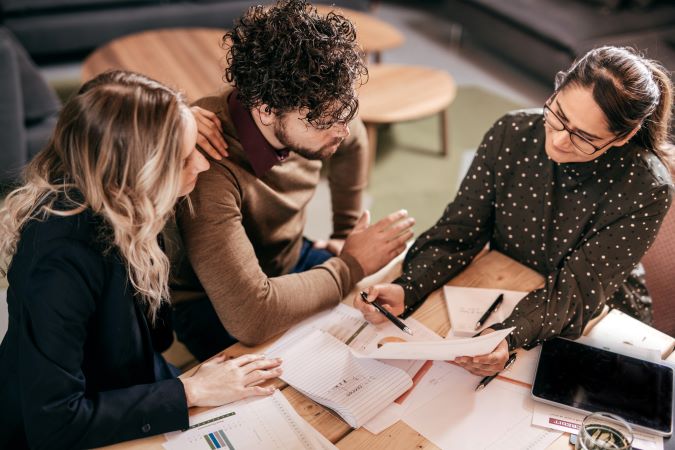 group of people look at financial papers 