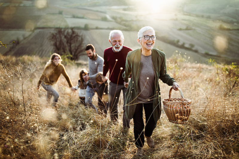 Family walking with fields behind.