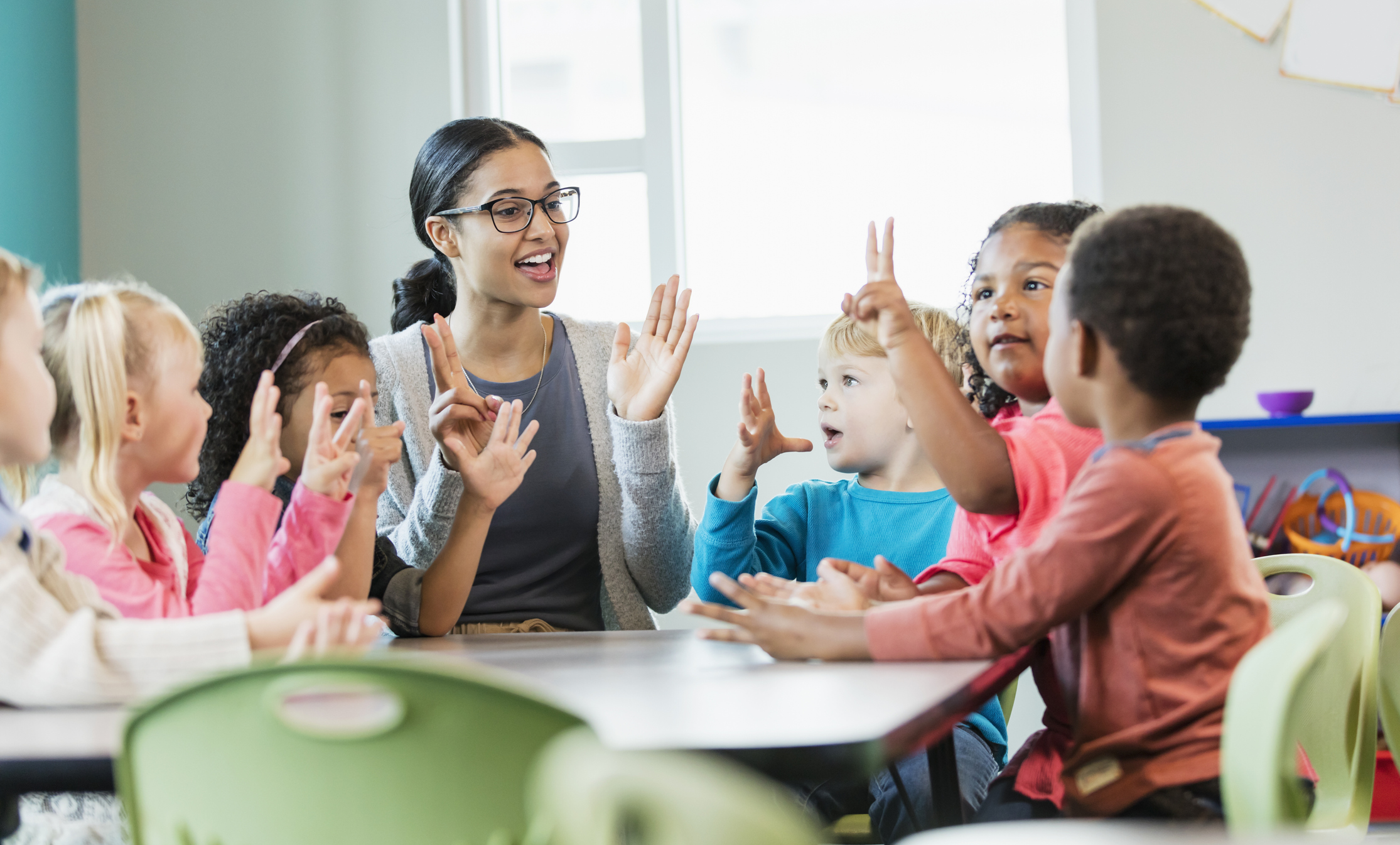 Group of children learning to count with teacher