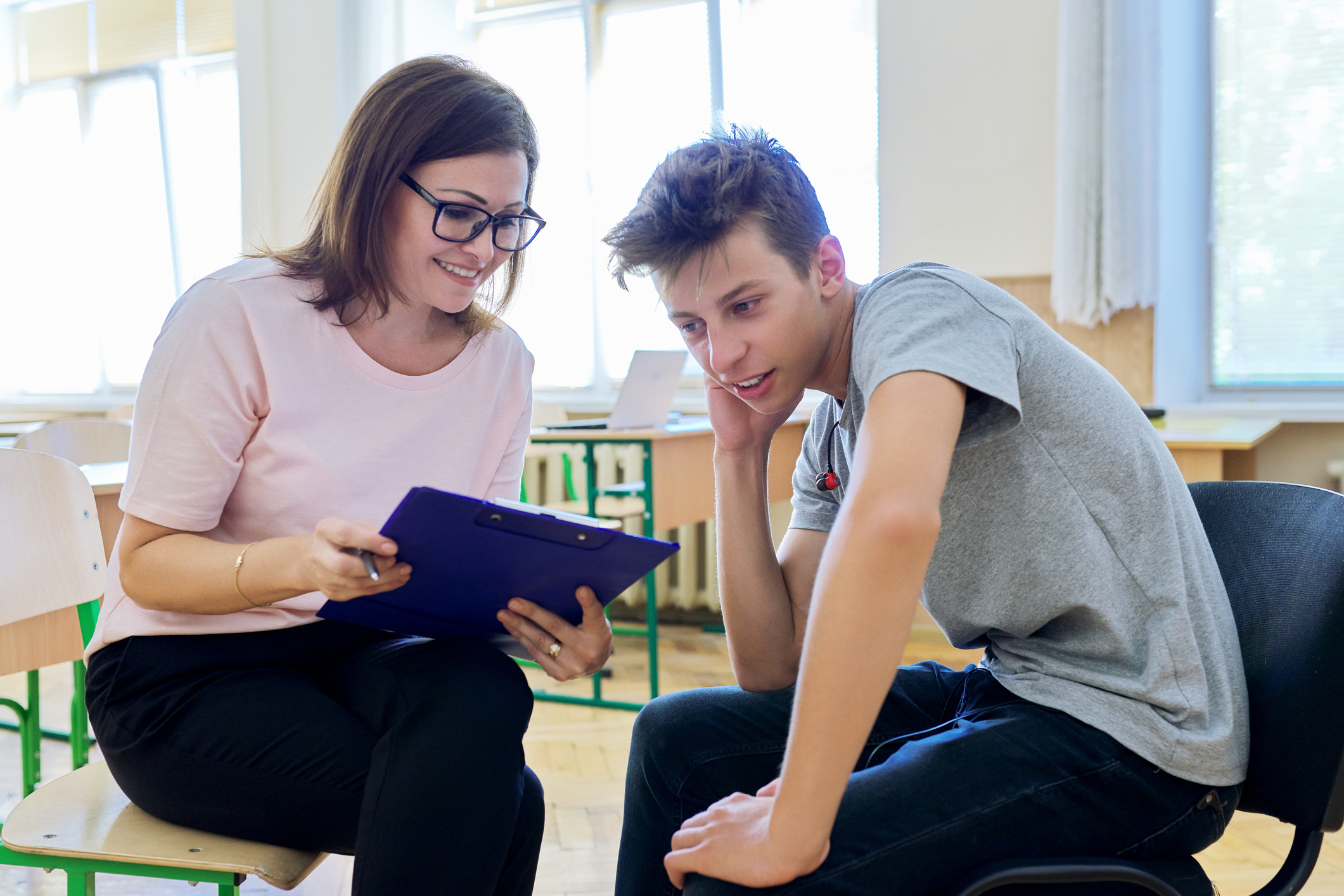 Adult reviewing information with adolescent.