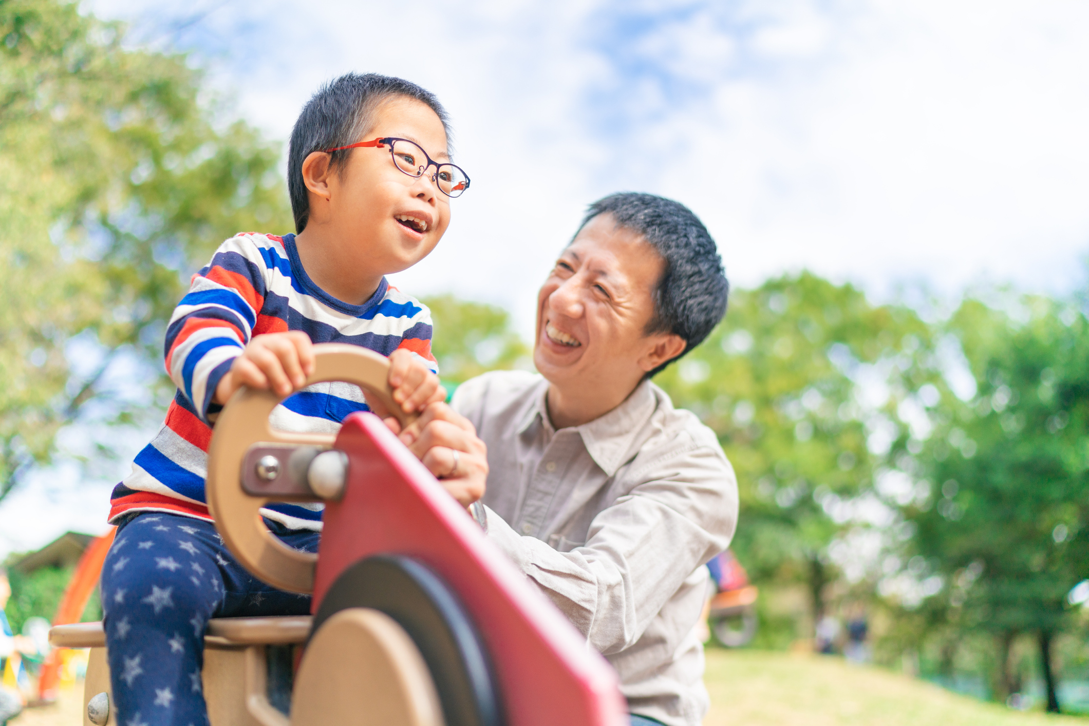 Foster parent playing with child at the park.