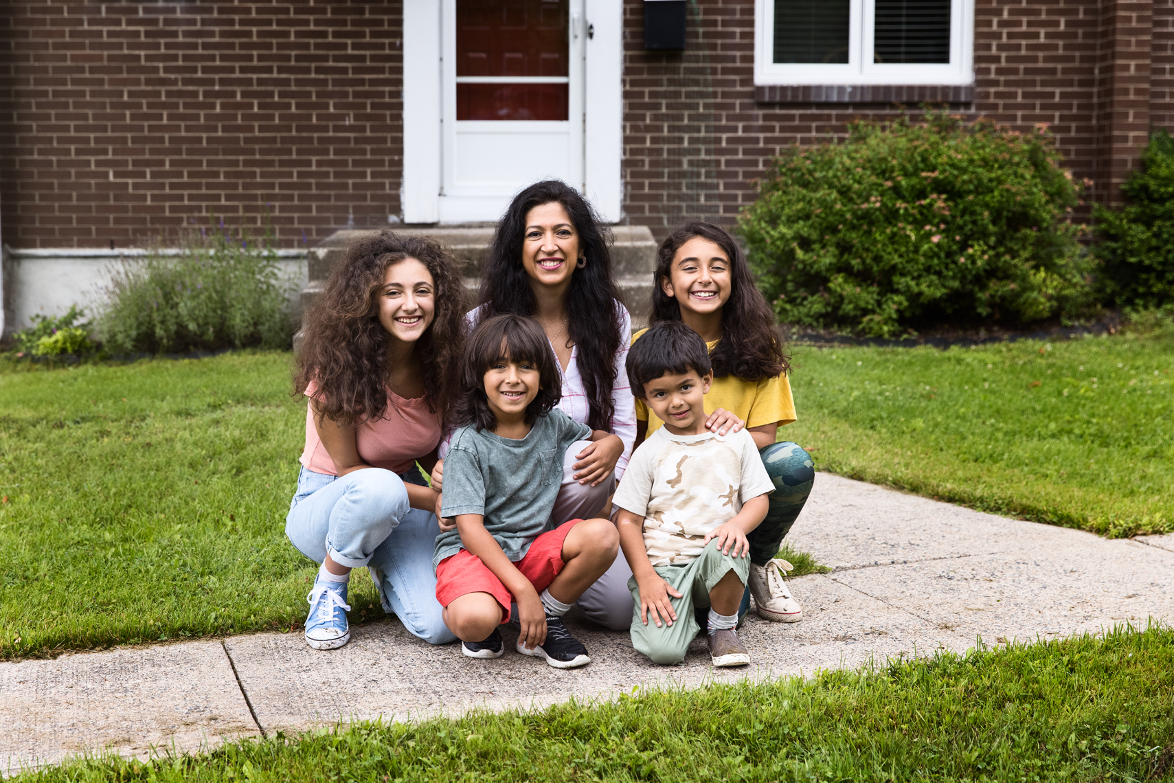 family in front of house.