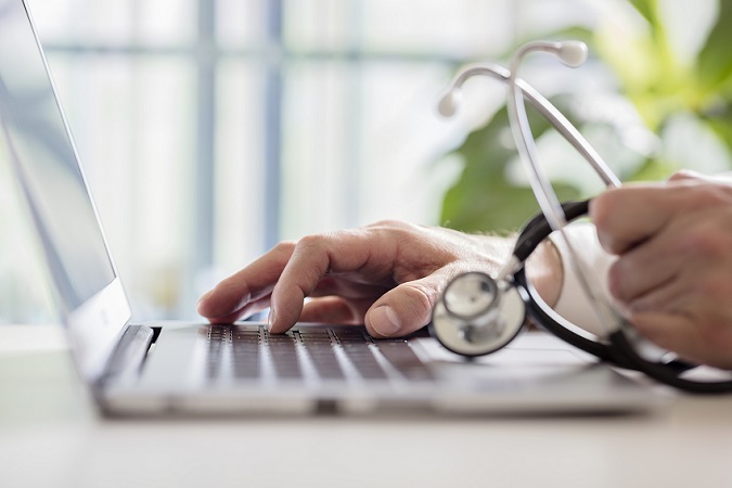 healthcare professional using laptop