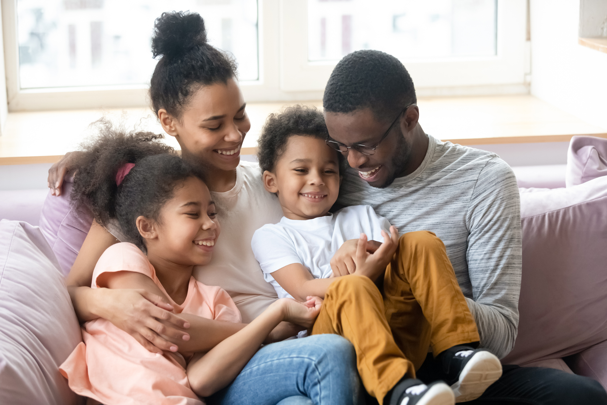 family with young children sitting on a couch